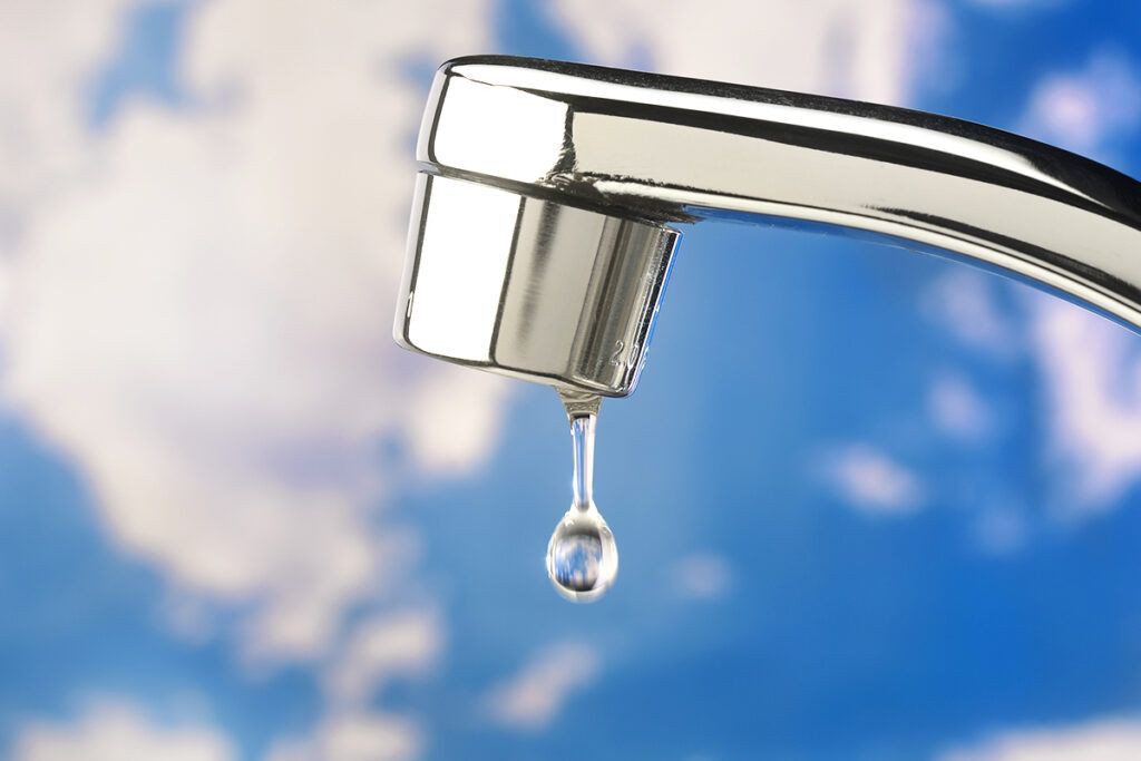 A faucet with a drip of water coming from it, representing GERD and postnasal drip.