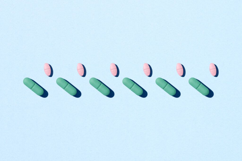 Picture of differently shaped pills in two rows depicting repeat prescriptions vs. new prescriptions