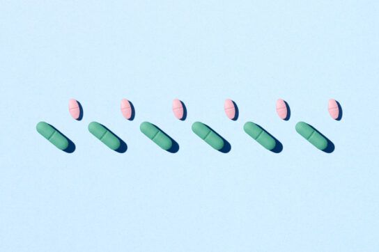 Picture of differently shaped pills in two rows depicting repeat prescriptions vs. new prescriptions