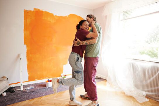 Couple achieving New Year's resolutions of painting their home