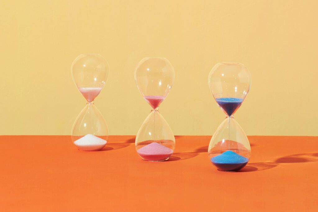 Multi-colored hourglasses representing how long ozempic stays in your system