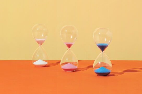 Multi-colored hourglasses representing how long ozempic stays in your system