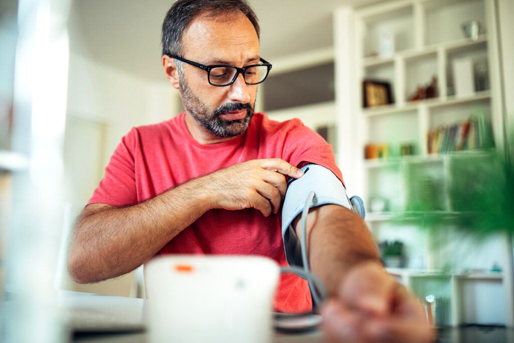 A man checking his blood pressure as Cialis may lower your blood pressure.