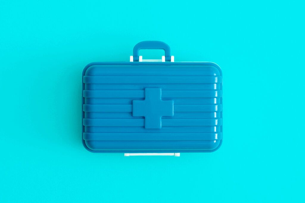 Image of a blue first aid box to depict how to travel with medication. 