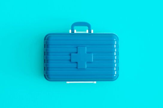 Image of a blue first aid box to depict how to travel with medication.