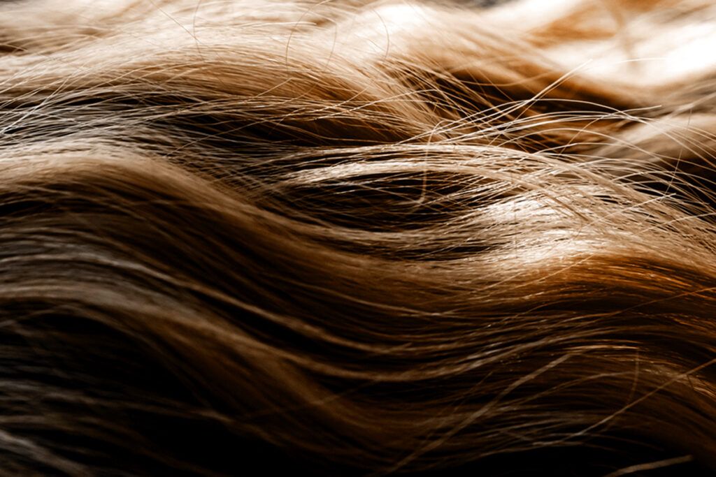 Close up of someone's wavy hair respresenting hair growth prescription