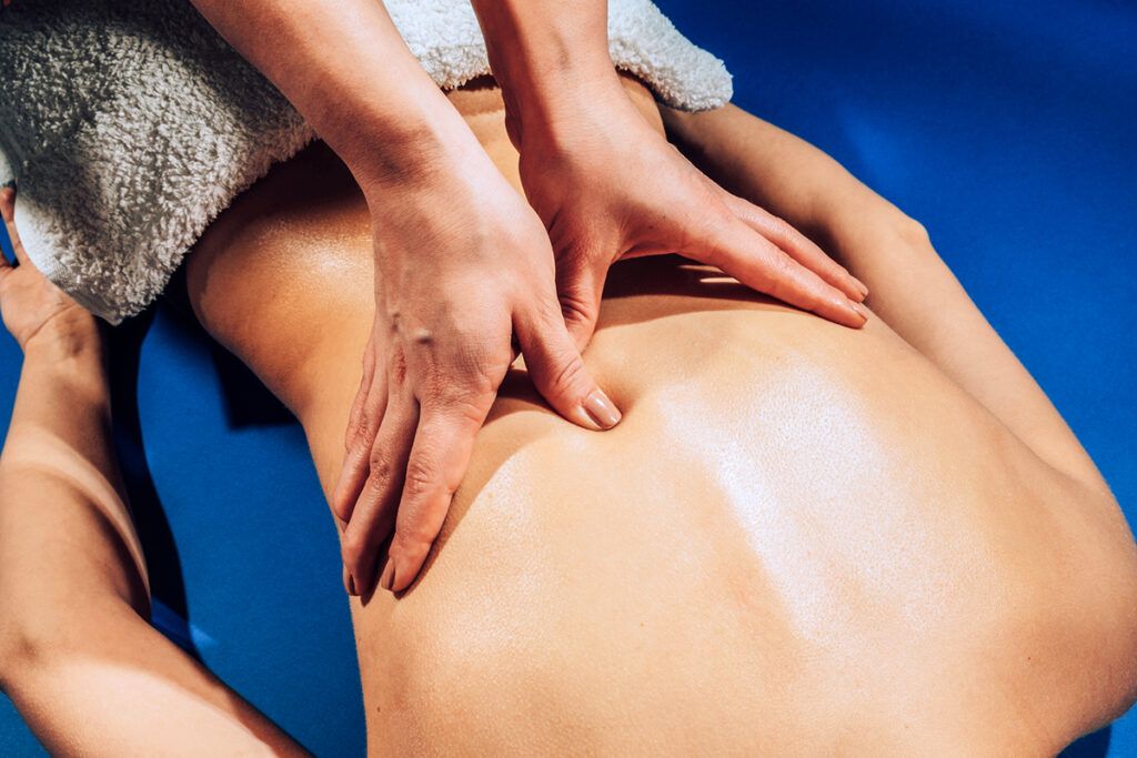 A person receiving a massage that may be covered by their insurance.
