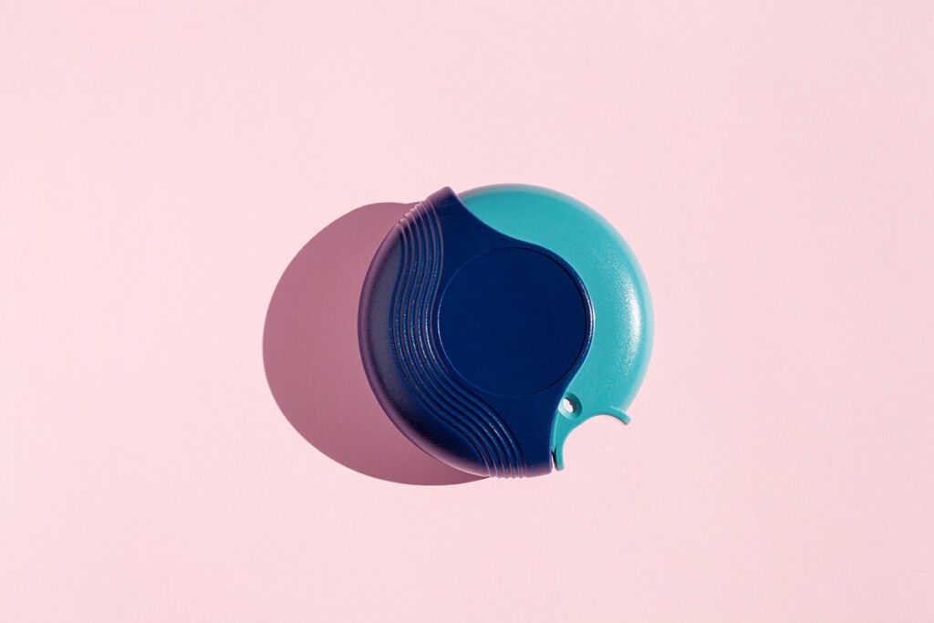 An Advair Diskus inhaler on a pink background, used for COPD.