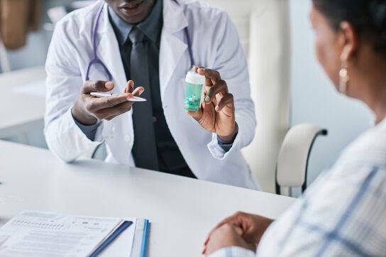 A healthcare professional showing a bottle of gabapentin to a patient and explaining what it does exactly.