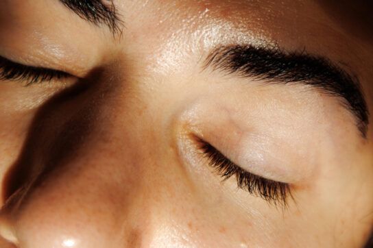 A zoomed-in picture of a person's closed eyes, focusing on the eyelashes.