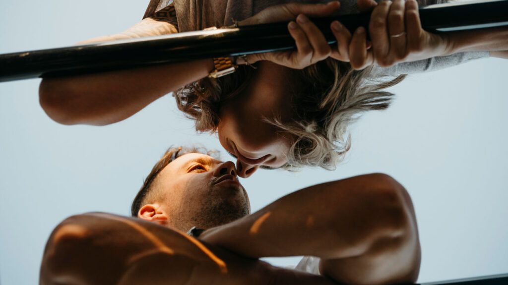 A view from below of a couple just about to kiss after one partner's cold sores have healed and gone away with the help of valacyclovir