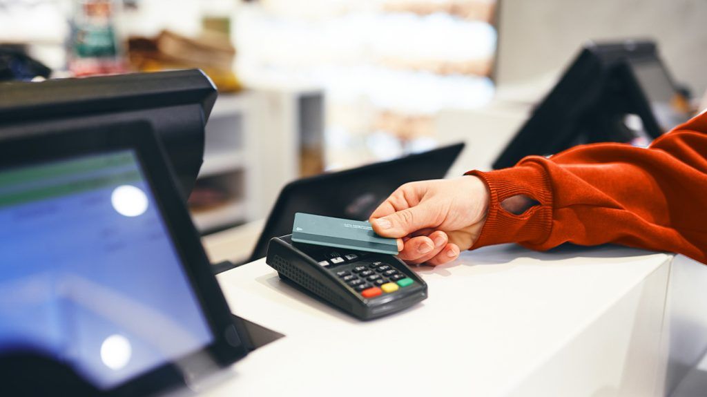 A person paying for their medications at a pharmacy.