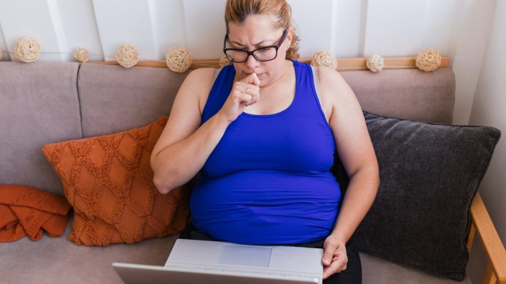 A woman researching HSAs on a laptop.